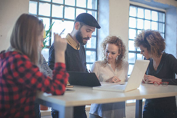 istock Multiracial group of young entrepreneurs gathered around work schedule 508312676