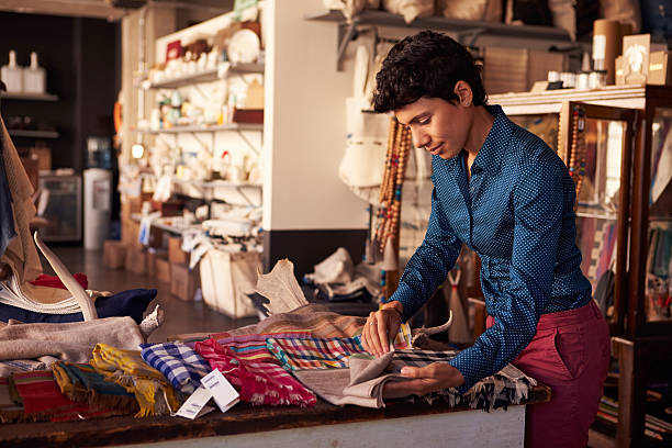 istock Female Sales Assistant Arranging Textiles In Homeware Store 508313016