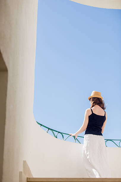 istock Young woman looking outside from terrace 508315274