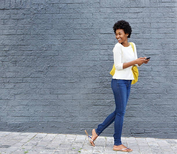 istock African woman with a cell phone looking over her shoulder 508315444