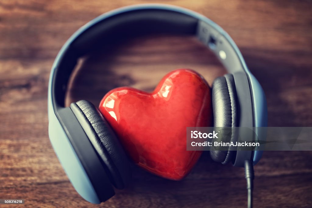 Love listening to music Headphones and heart concept for love listening to music Music Stock Photo