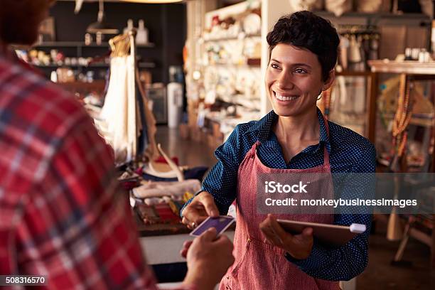 Sales Assistant With Credit Card Reader On Digital Tablet Stock Photo - Download Image Now