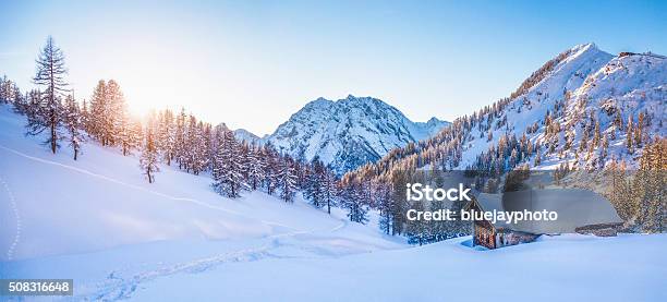 Winter Wonderland In The Alps With Mountain Chalet At Sunset Stock Photo - Download Image Now