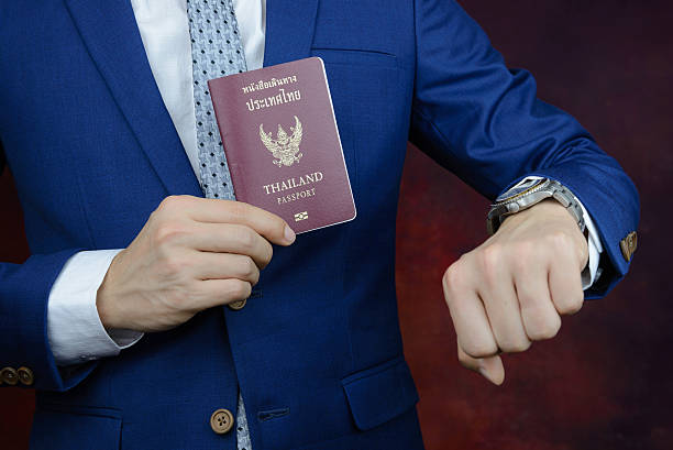 istock businessman showing passport, check time on watch 508316826