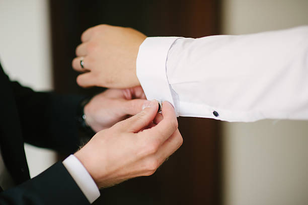 istock groom fastening a cuff-link 508319222