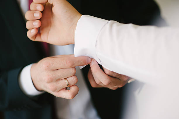 istock groom fastening a cuff-link 508319652