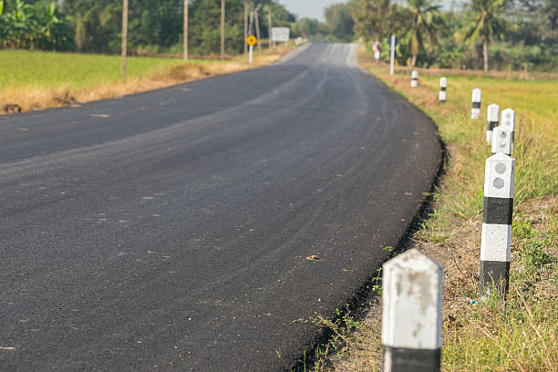 istock Country Road and pillar Through Farmland 508320374