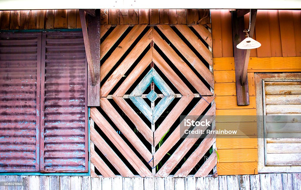 Exterior house multi-shaped decoration Multi-colored, geometrically shaped part of the house wall in the fisherman's village in Koh Kood island, Thailande. Backgrounds Stock Photo