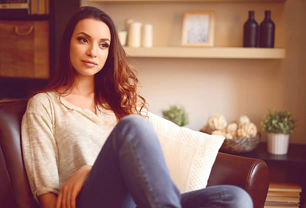 istock young brunette woman in home interior 508323170