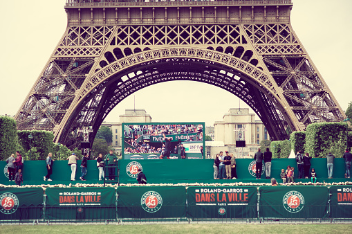 Paris, France June 1, 2015: Caption of lower half Eiffel Tower as seen from the ground.