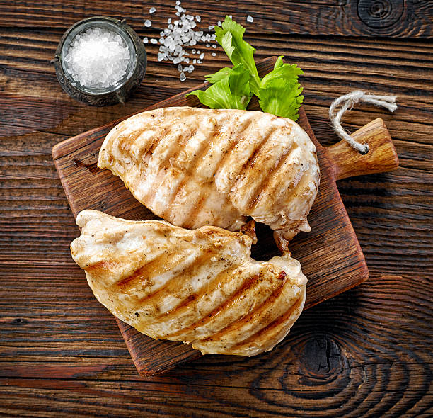 grilled chicken fillets grilled chicken fillets on wooden cutting board, top view grilled chicken breast stock pictures, royalty-free photos & images