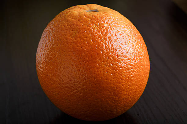 istock Orange on wooden background macro 508328468