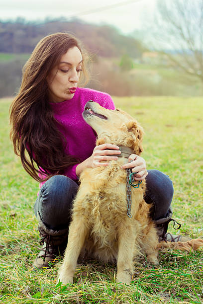 istock attractive girl in the grass with a dog 508328780