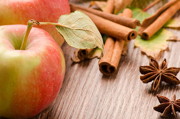 istock Red apple, sticks of cinnamon and anise on a table 508339224