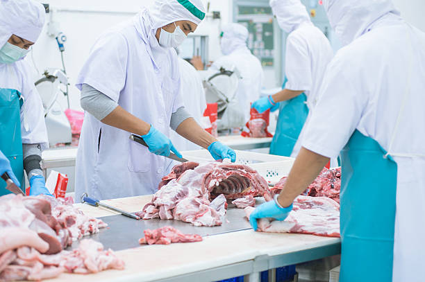 istock cutting meat slaughterhouse workers in the factory 508340180