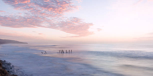 St. Clair Beach in Dunedin, New Zealand Sunrise at St. Clair Beach in Dunedin, New Zealand old jetty dunedin stock pictures, royalty-free photos & images