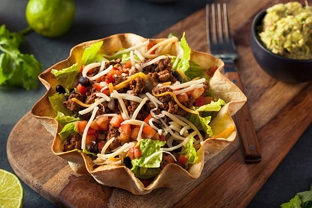 Taco Salad in a Tortilla Bowl Taco Salad in a Tortilla Bowl with Beef Cheese and Lettuce Taco Salad stock pictures, royalty-free photos & images