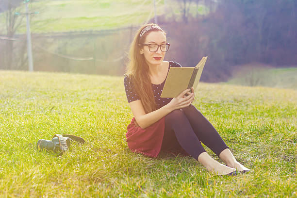istock Girl with a book in nature 508341316