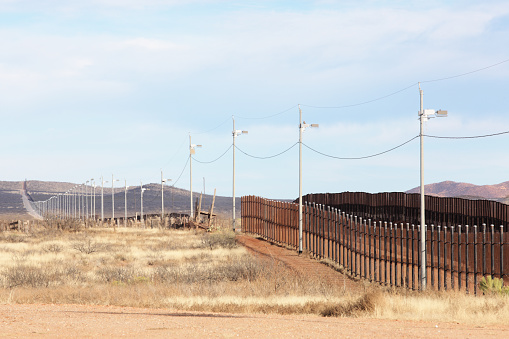United States Mexico border fence illegal immigration barrier from the American side.