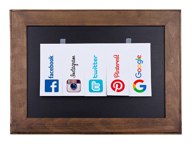 popular social media icons Kiev, Ukraine - October 15, 2015:Facebook, Twitter; Instagram, Pinterest and Google logos printed on paper and placed on a blackboard. pinterest stock pictures, royalty-free photos & images