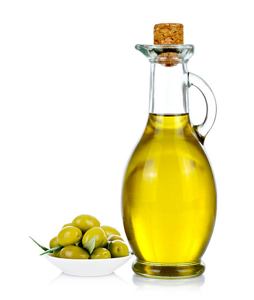 Bottle of olive oil with olives on white Bottle of olive oil with olives on white background. olive oil pouring antioxidant liquid stock pictures, royalty-free photos & images