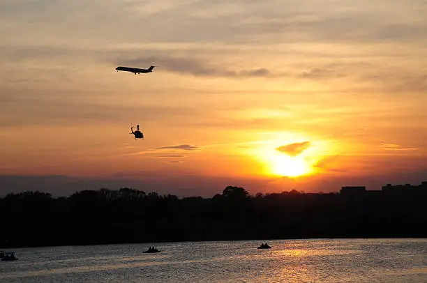 Sunset on the Tidal Basin. With a plane getting ready to land and a helicopter crossing under 