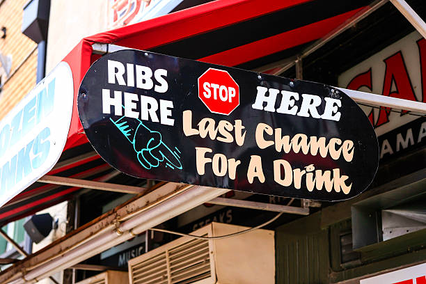Memphis, TN, USA - August 5, 2015: Ribs Stop Here - Last Chance for a Drink overhead sign outside a cafe on Beale Street in Memphis Tennessee