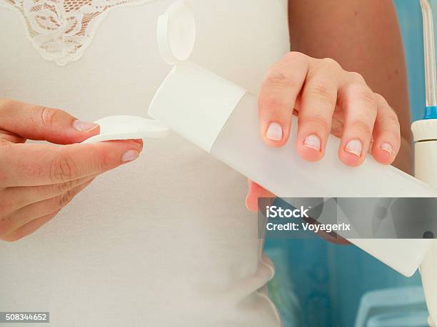 Woman Holding Cotton Swab And Makeup Remover In Hands Stock Photo - Download Image Now