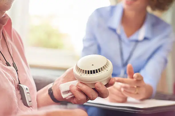 Photo of housing officer and tenant smoke alarm chat