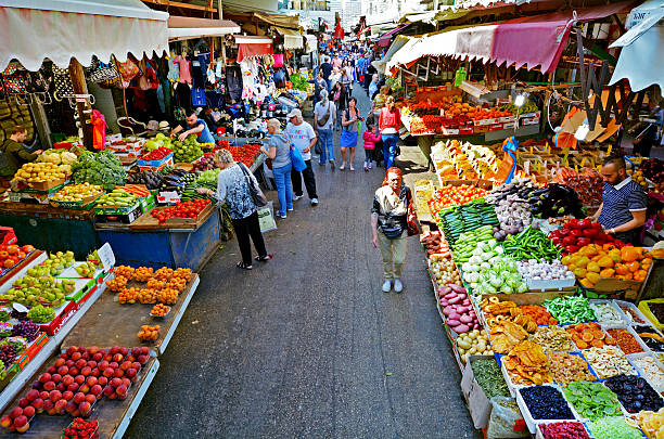 Carmel Market Shuk HaCarmel in Tel Aviv - Israel Tel Aviv, Israel - April 6, 2015: Shoppers at Carmel Market Shuk HaCarmel in Tel Aviv, Israel. Carmel market is a very popular marketplace in Tel Aviv sells mostly food and home accessories goods. tel aviv photos stock pictures, royalty-free photos & images
