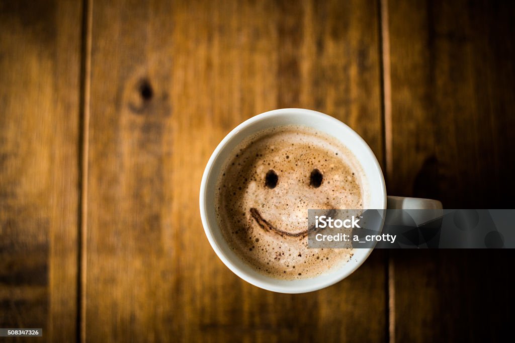 Happy Coffee Cup A sad looking Coffee Cup on a brown rustic table. Coffee Break Stock Photo