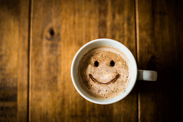 Happy Coffee Cup A sad looking Coffee Cup on a brown rustic table. break time stock pictures, royalty-free photos & images