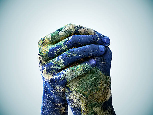We are the world A cropped shot of hands painted to look like the earth planet earth photos stock pictures, royalty-free photos & images