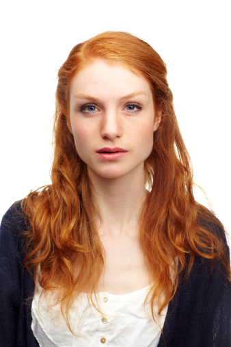 Studio portrait of an attractive redhead isolated on white