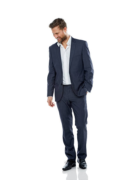 Successful young businessman looking down smiling