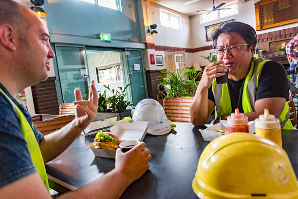 istock Workmen Relaxing With Beer After Work in High Visibility Clothes 508349588