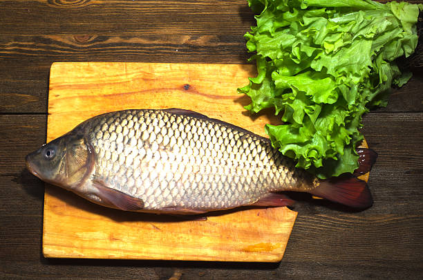 istock raw fish on wooden table as background 508350834