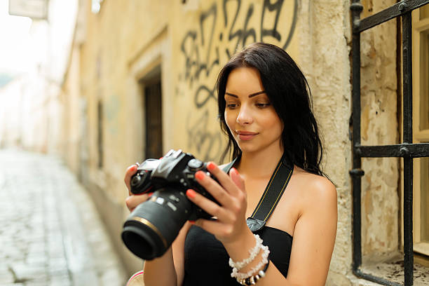 istock Beautiful girl relaxing with digital SLR camera 508352791