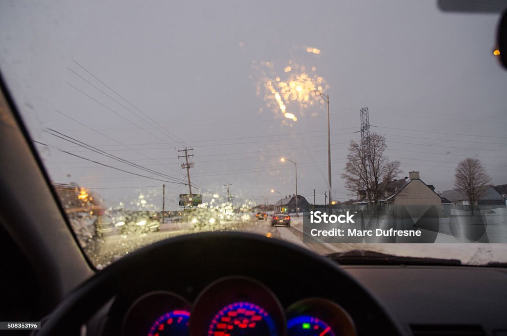 View from inside car while driving night snowstorm View from inside car, driver's point of view, while driving during a winter snowstorm at night, with cars in front Car Stock Photo