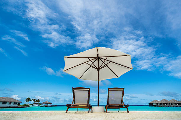 istock Beach lounger and umbrella on sand beach 508353575