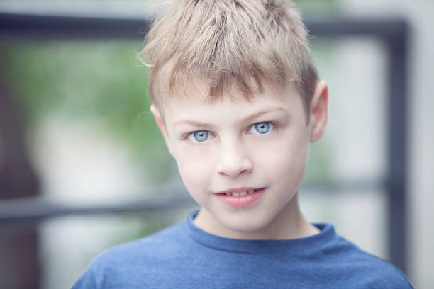 Blonde blue eyed little boy smiling