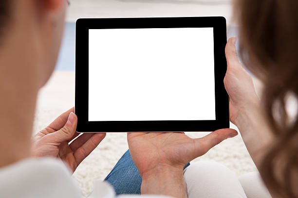 istock Young couple looking at a tablet together 508354819
