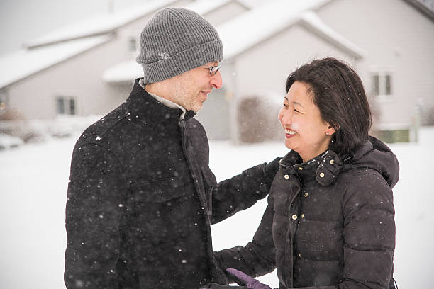 istock Multy-ethnic couple have fun outdoor under the snowfall 508372164