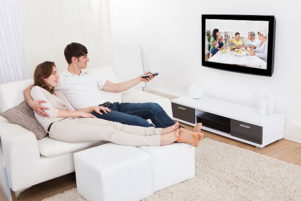 istock Couple In Livingroom Watching Television 508372339
