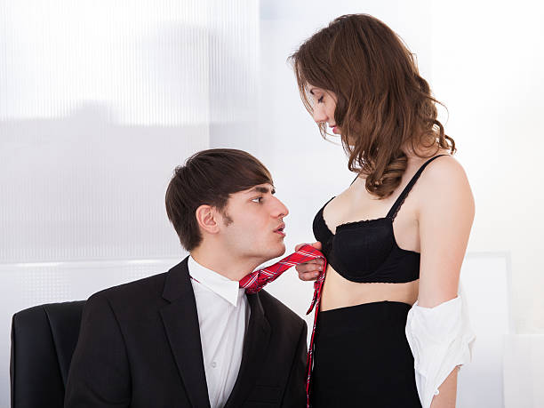 istock Undressed Businesswoman Pulling Boss Towards Self In Office 508372357
