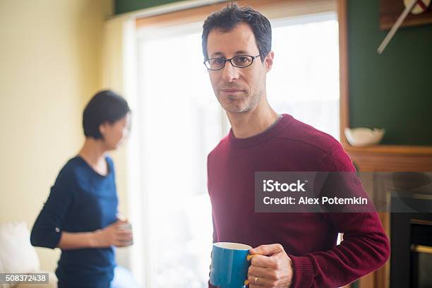 Multiethnic Family Caucaian Man And Korean Woman At Home Stock Photo - Download Image Now