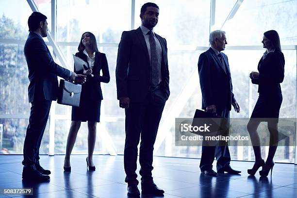 Business People In Lobby Stock Photo - Download Image Now - 30-39 Years, Active Seniors, Adult