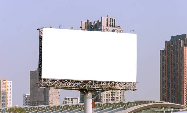 istock large blank billboard on road with city view background 508372835
