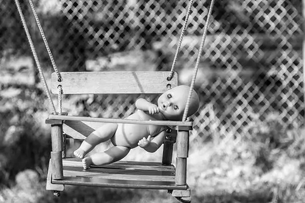 Baby-doll on the swing