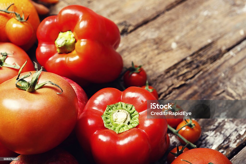 Lycopene to help prevent prostate cancer packed into red vegetables Packed with the protective anti-oxidant lycopene, which helps protect against cancer, especially of the prostate, bright red tomatoes and sweet peppers  sit on wood. Antioxidant Stock Photo